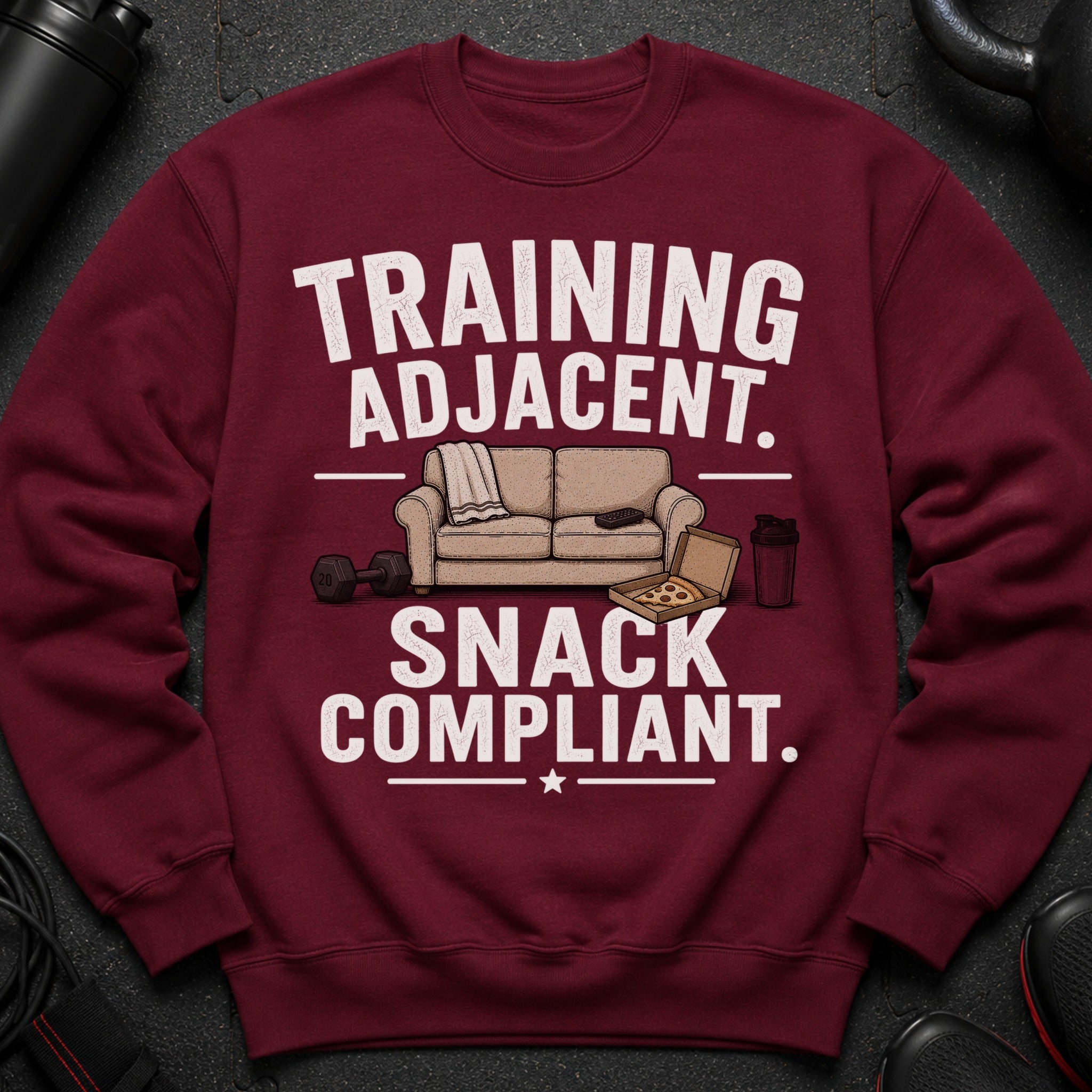 Maroon sweatshirt with "TRAINING ADJACENT. SNACK COMPLIANT." text and cartoon graphics.