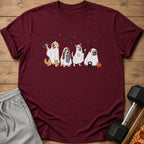 Four dogs in ghost costumes holding workout gear and a pumpkin on a maroon shirt.