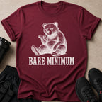 Maroon t-shirt with a drawing of a tired bear lifting a dumbbell, text reads "BARE MINIMUM".
