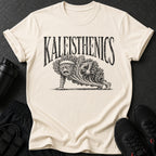 Cream t-shirt with "KALEISTHENICS" and kale character doing a plank with dumbbells.