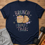 T-shirt with "Brunch Built This" text and cartoon pancakes and croissant flexing.