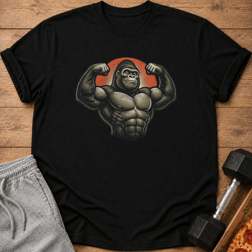 Black t-shirt with muscular gorilla graphic, next to grey sweatpants and dumbbell.