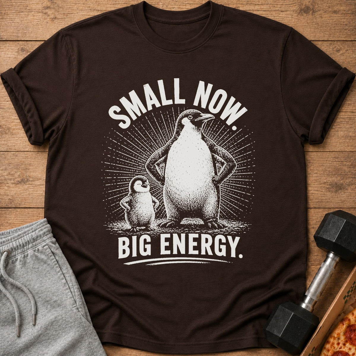 Brown t-shirt with penguins and text "SMALL NOW. BIG ENERGY."