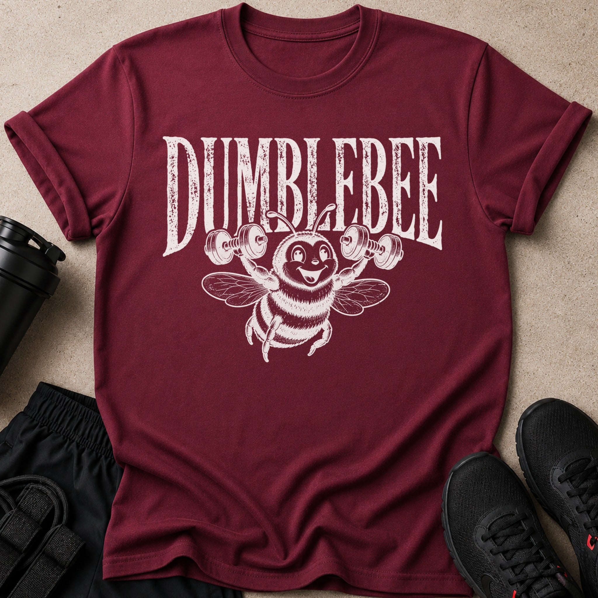 Maroon t-shirt with distressed "DUMBLEBEE" text and a cartoon bee lifting weights.