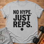 Gray t-shirt with black text "NO HYPE. JUST REPS." and a weight plate graphic.