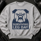Grey sweatshirt with a dark blue bulldog graphic and "Surviving Leg Day" text.