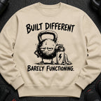 Kettlebell character wearing shoes, holding a shaker bottle, with text "Built Different Barely Functioning."