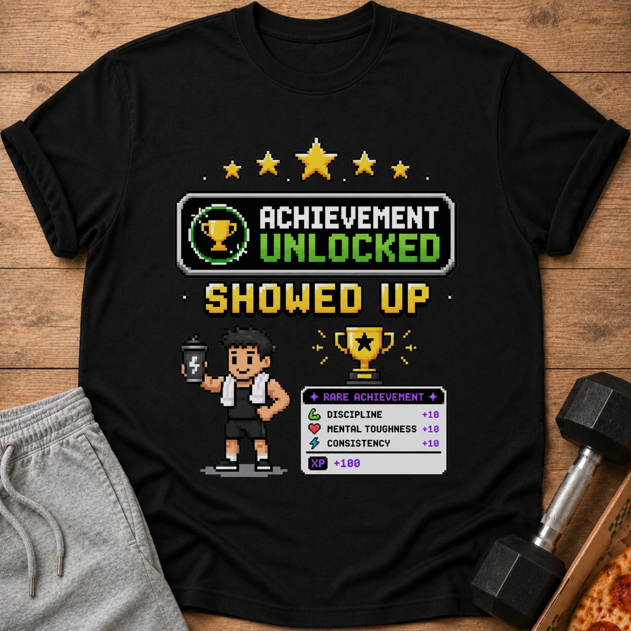 Black t-shirt with "Achievement Unlocked Showed Up" pixel art.