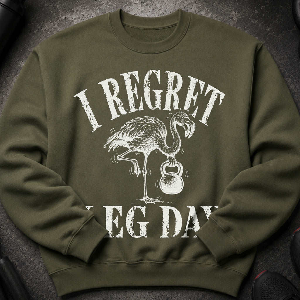 Green sweatshirt with white text "I REGRET" and a flamingo holding a kettlebell, "LEG DAY" below