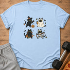 Light blue t-shirt with four black cats in Halloween costumes: witch, ghost, vampire, and mummy.