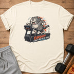Cream t-shirt with a distressed graphic of a cat running on a treadmill.