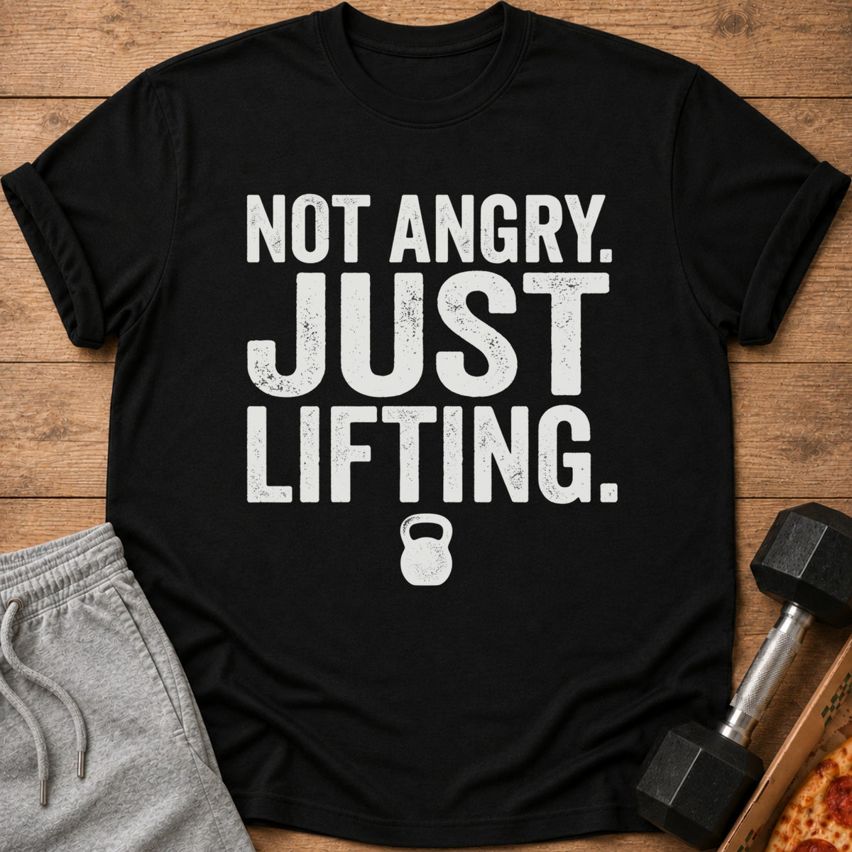 Black t-shirt with "Not Angry. Just Lifting." text and kettlebell graphic.