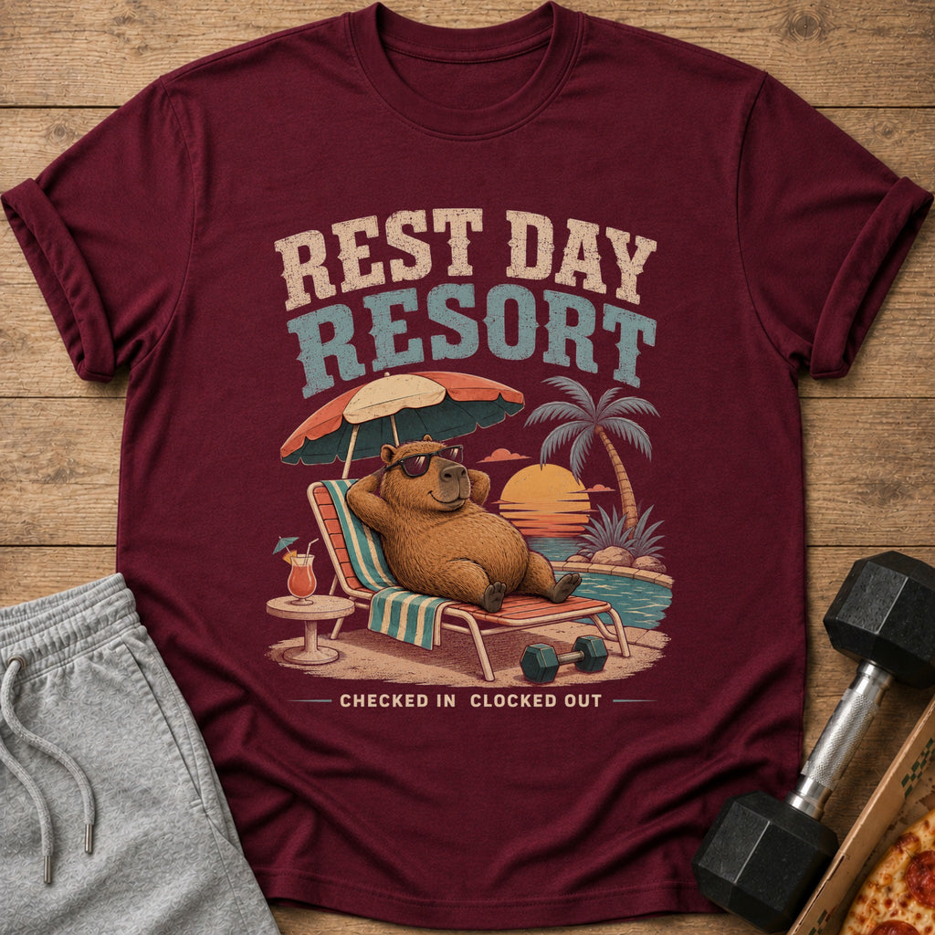 Maroon t-shirt with "Rest Day Resort" graphic of a capybara relaxing by a pool.