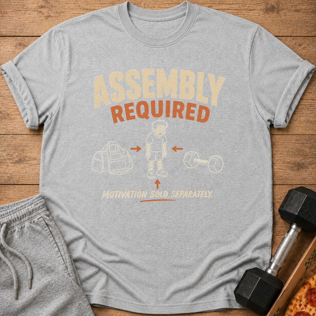 Gray t-shirt with "Assembly Required" and graphics of gym bag, tired person, dumbbell.