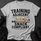 Grey t-shirt with "TRAINING ADJACENT SNACK COMPLIANT" text and graphics.