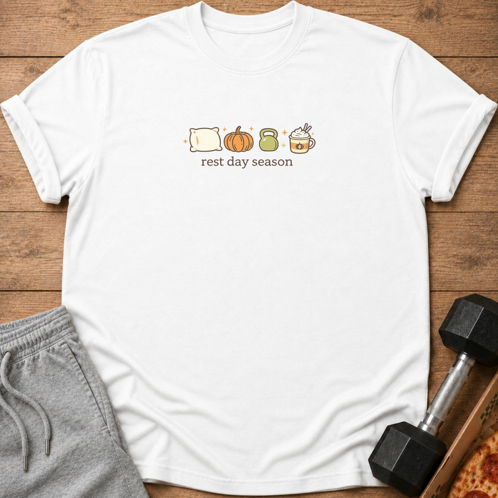 White t-shirt with "rest day season" text and icons of a pillow, pumpkin, kettlebell, and coffee.