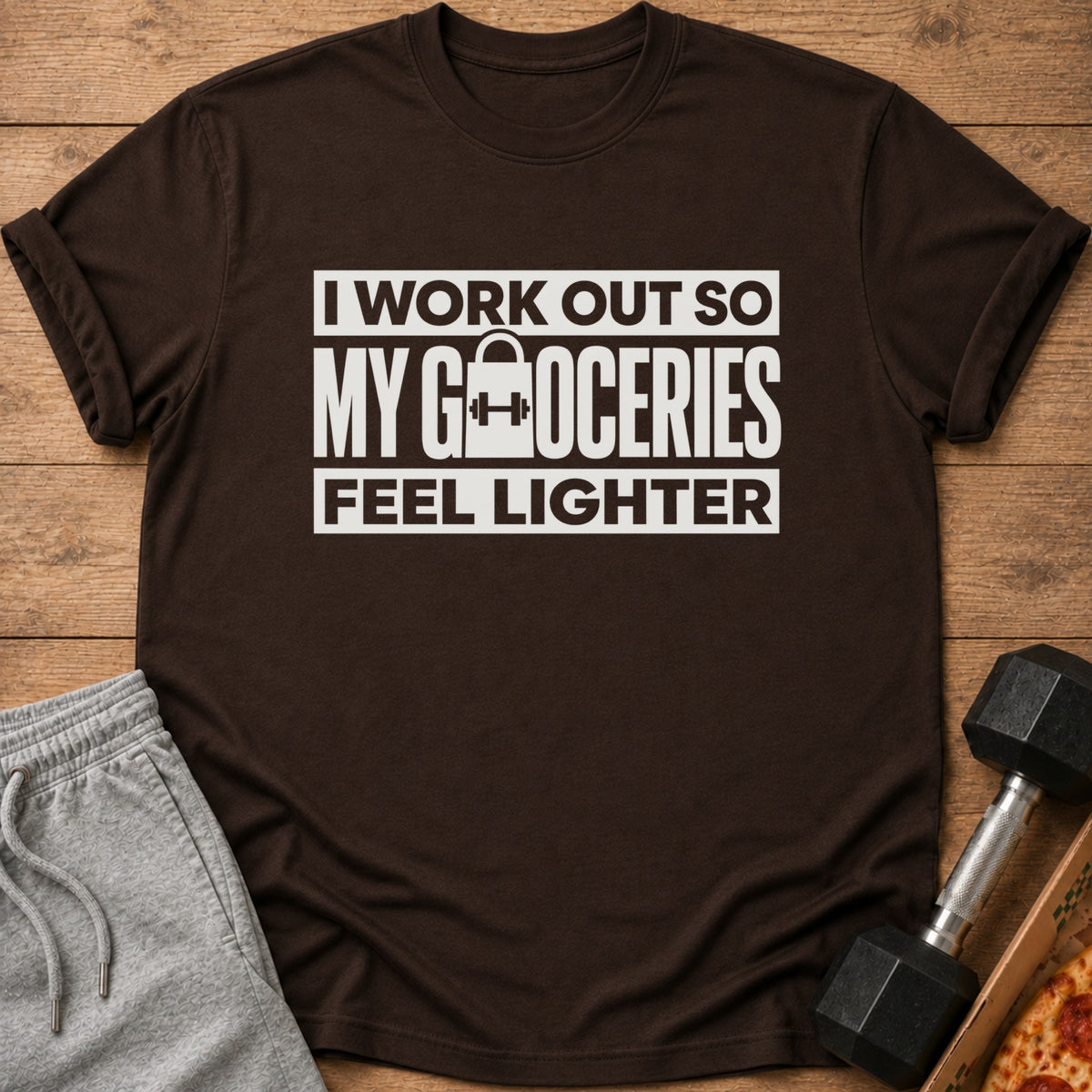Brown t-shirt with white text "I WORK OUT SO MY GROCERIES FEEL LIGHTER."