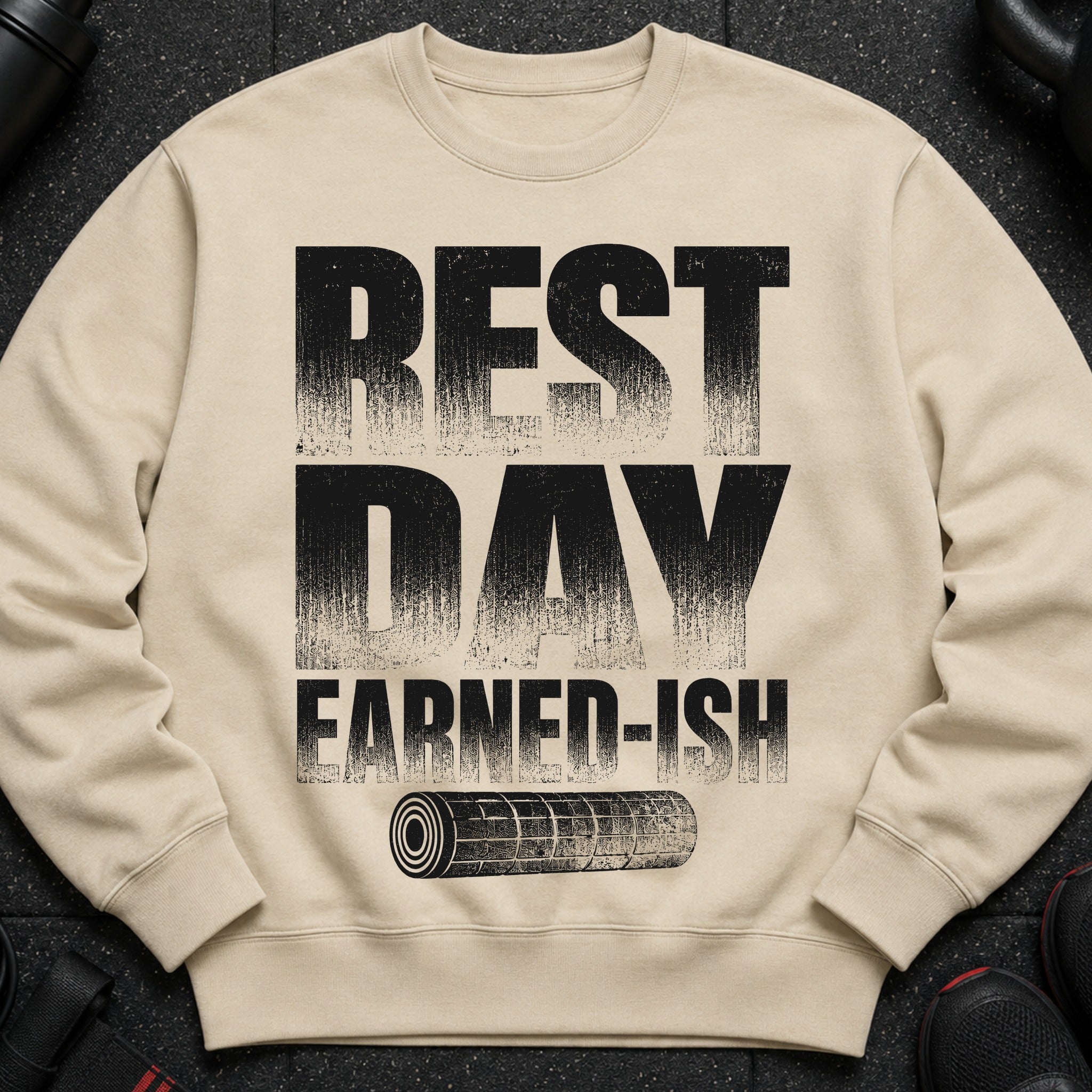 Cream sweatshirt with "REST DAY EARNED-ISH" text and a foam roller graphic.