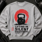Grey sweatshirt with graphic of angry kettlebell and text ""Lifting in Silent Disapproval""