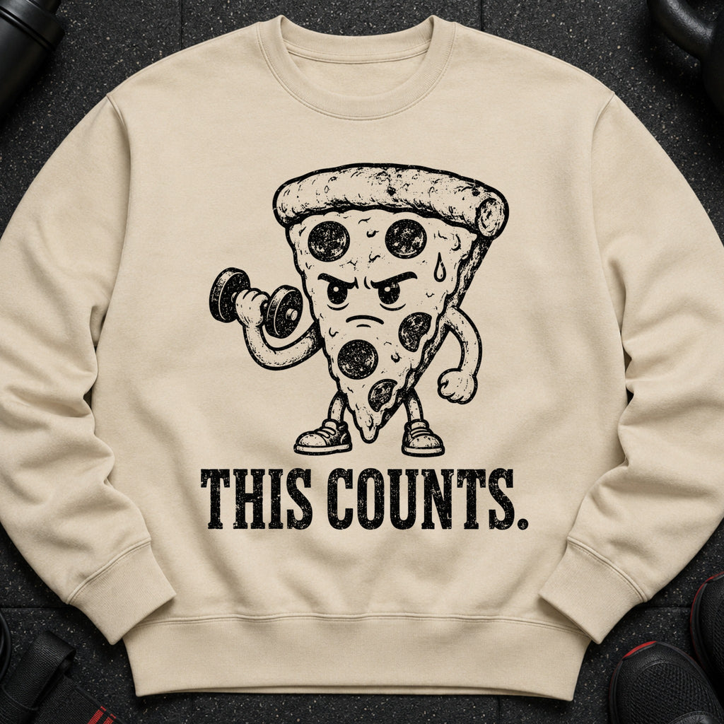 Light brown sweatshirt with a distressed graphic of a pizza slice lifting a dumbbell and the text "THIS COUNTS."