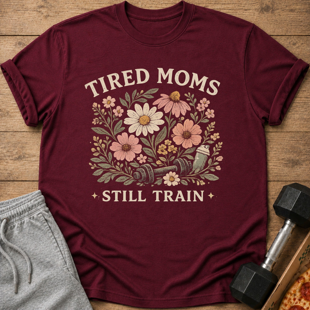 Maroon t-shirt with floral design and text "Tired Moms Still Train".