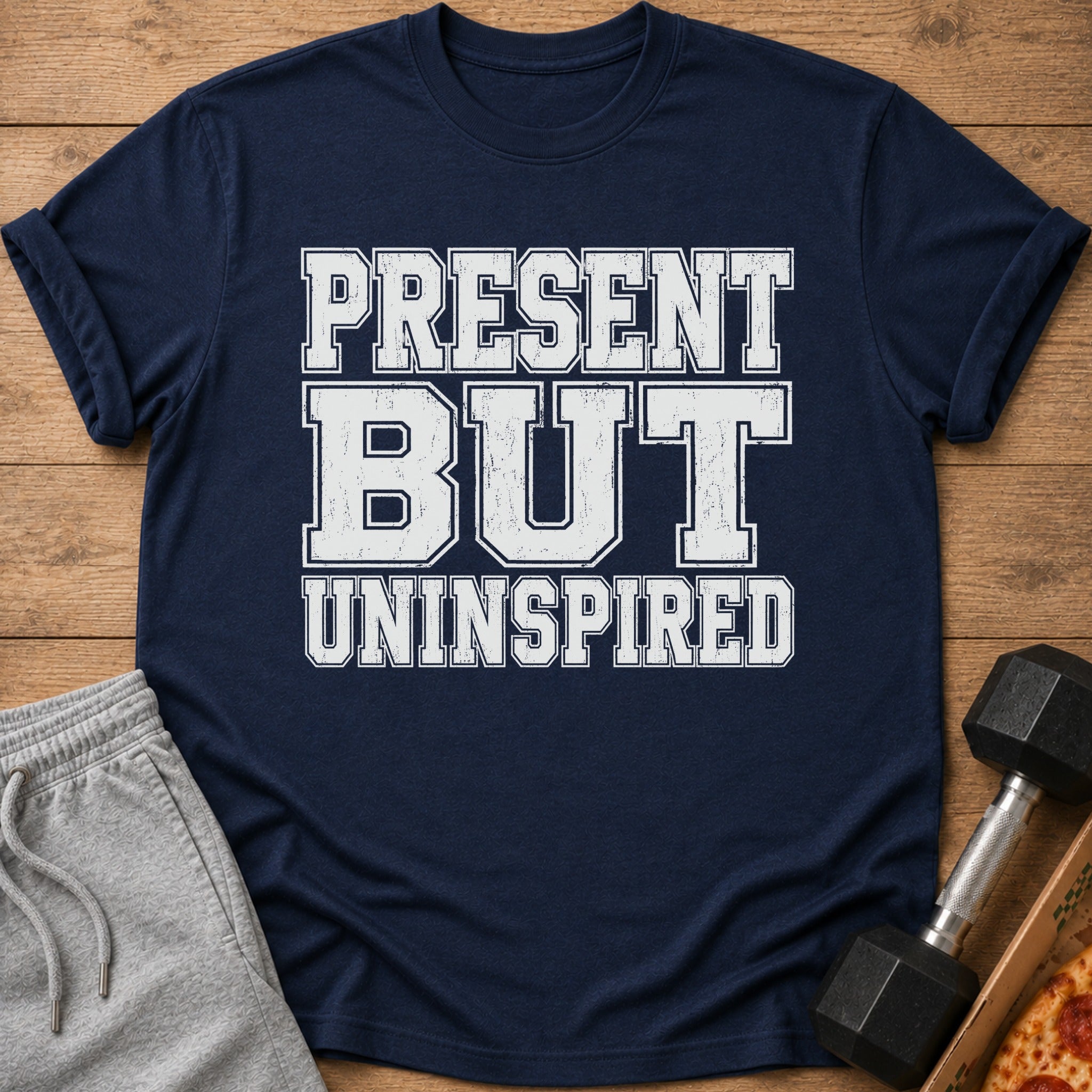 Navy t-shirt with white distressed text "PRESENT BUT UNINSPIRED".