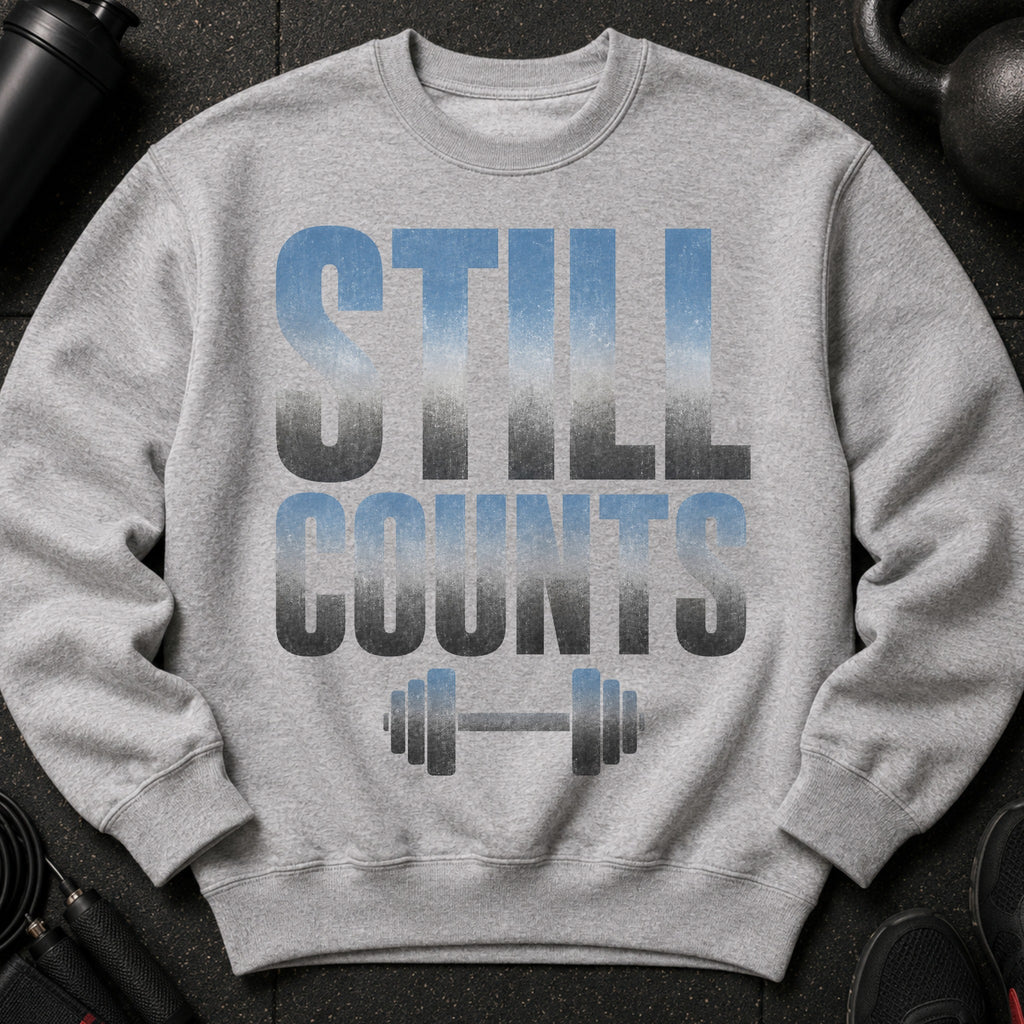 Gray sweatshirt with "STILL COUNTS" text and a dumbbell graphic.