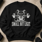 Black sweatshirt with a white graphic of a mouse lifting a barbell; text says "SMALL BUT LEGIT."