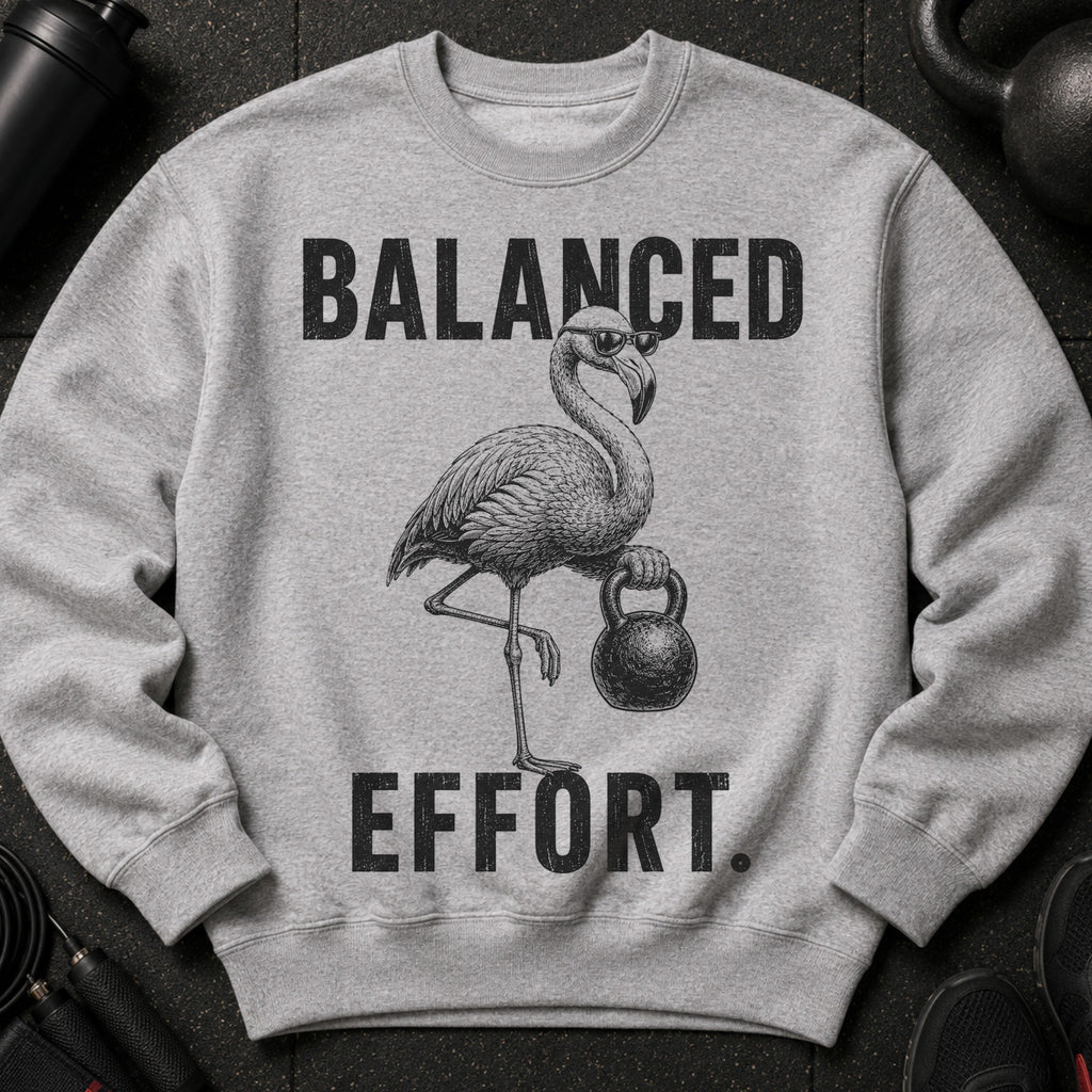 Grey sweatshirt with text "BALANCED EFFORT" and a flamingo lifting a kettlebell.