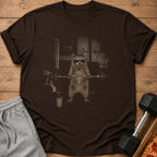 T-shirt with graphic of a raccoon wearing sunglasses and headband lifting weights.