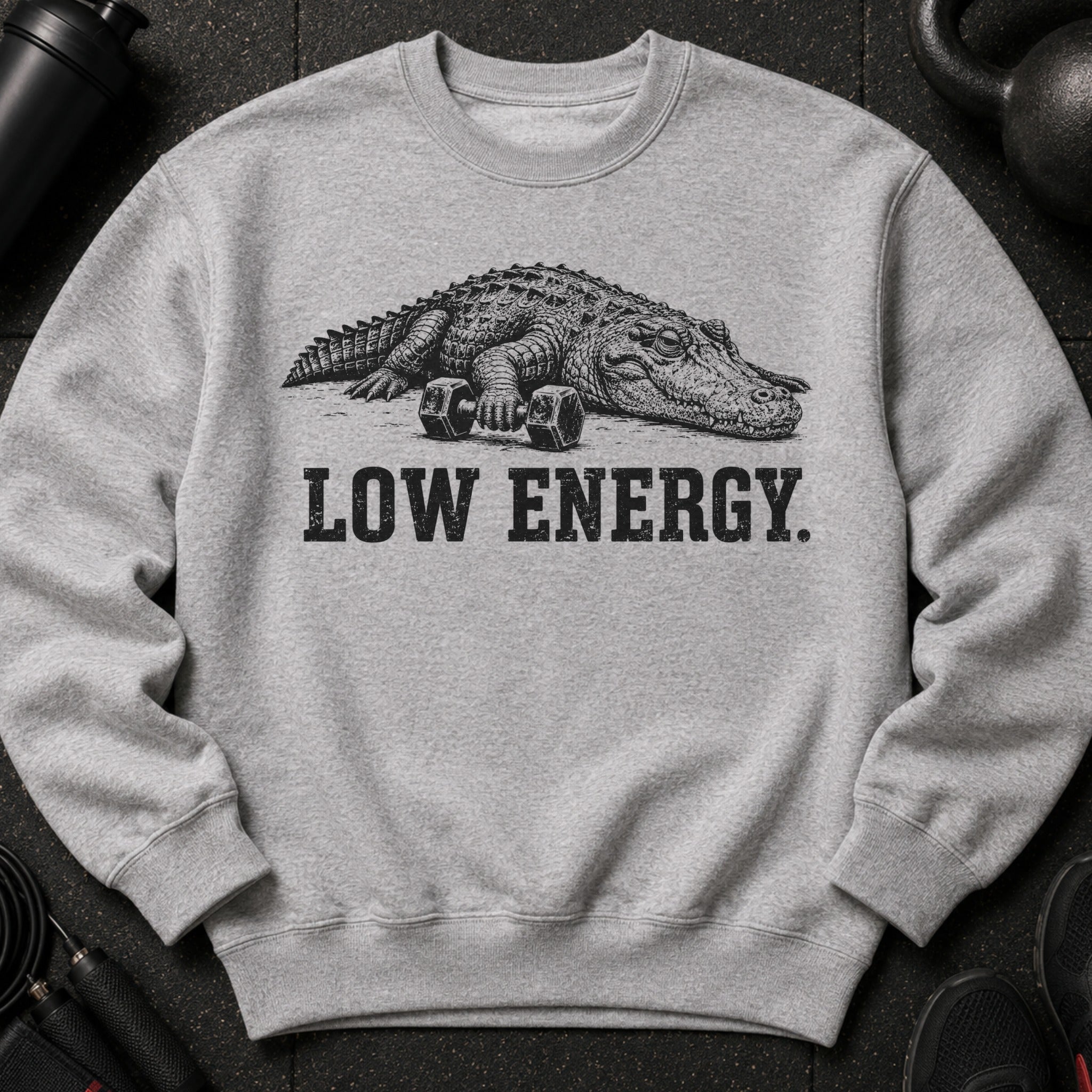 Alligator with dumbbells, text "LOW ENERGY" on grey sweatshirt.
