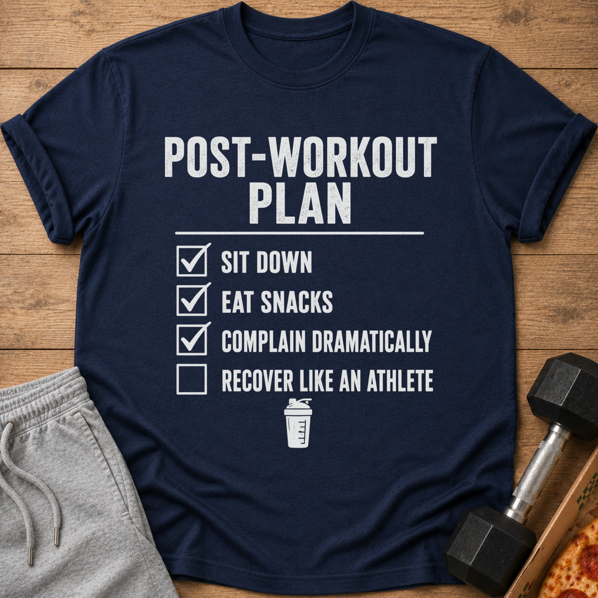 Navy t-shirt with "Post-Workout Plan" and a checklist including "Sit Down", "Eat Snacks", "Complain Dramatically", "Recover Like an Athlete".
