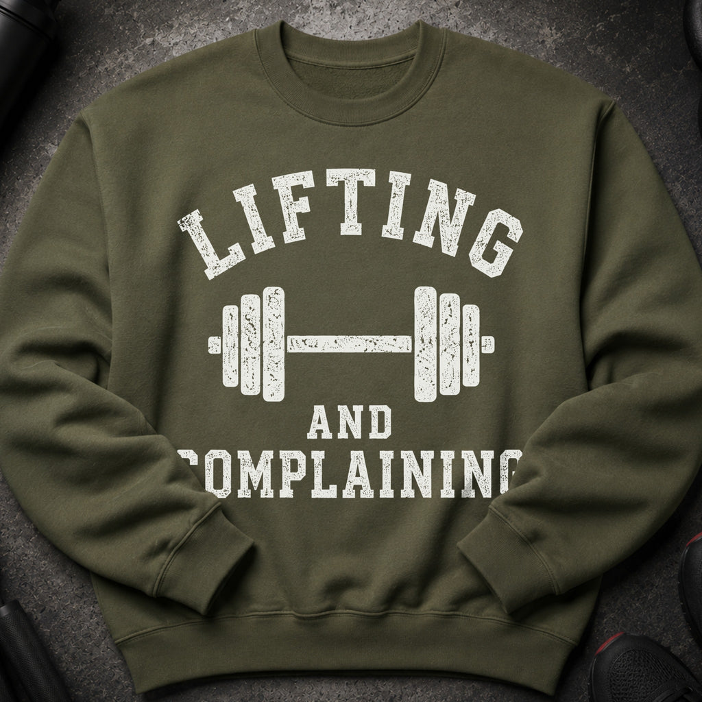 Olive green sweatshirt with white distressed text "LIFTING AND COMPLAINING" and dumbbell graphic.