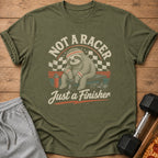 Green t-shirt with sloth graphic saying "Not a Racer Just a Finisher."