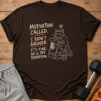 Dark brown t-shirt with a cat on a treadmill and text "Motivation called. I didn't answer."