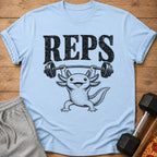 Light blue t-shirt with black graphic of axolotl lifting weights and text "REPS".