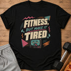 Black t-shirt with "Fitness, But Make It Tired" text and a tired cartoon TV.