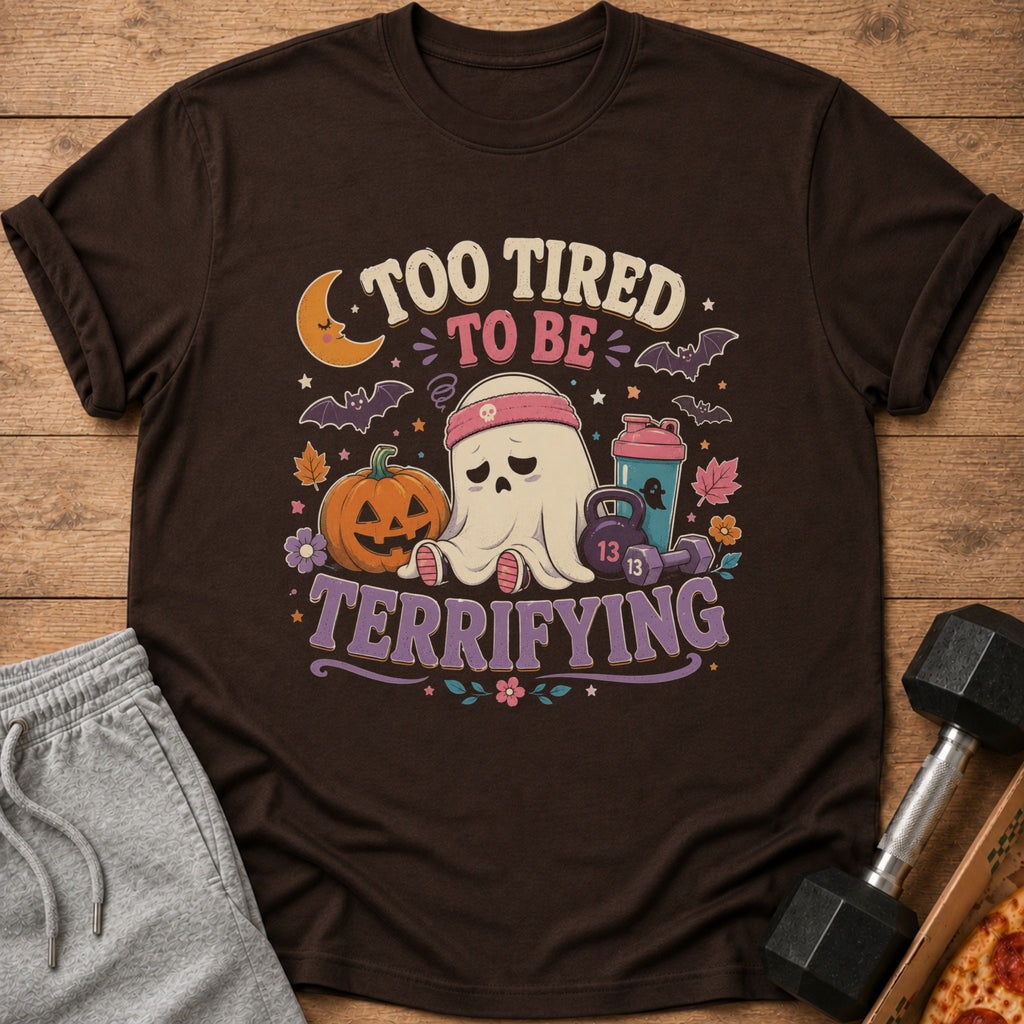 Brown t-shirt with "Too Tired to Be Terrifying" text and a tired ghost with gym equipment.