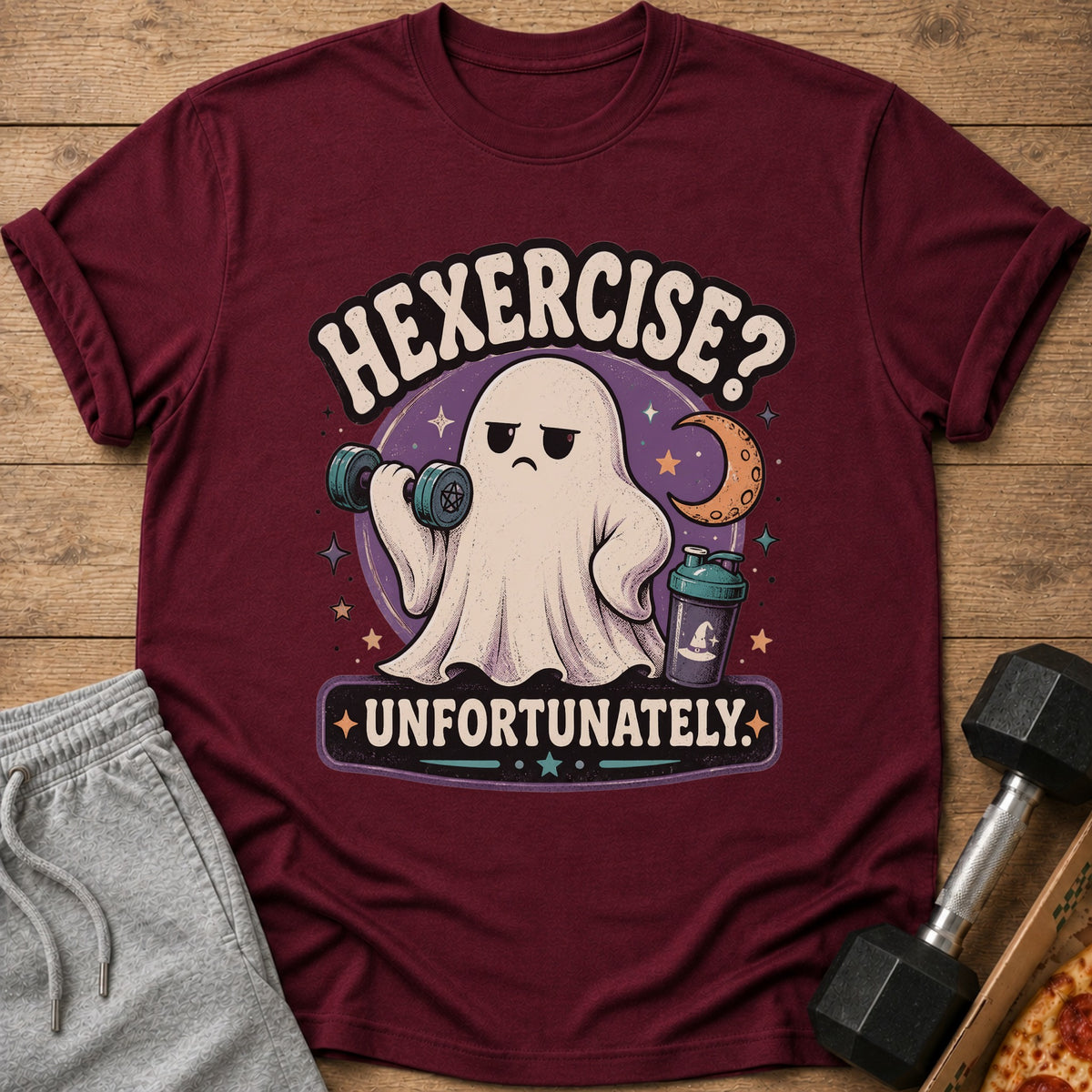 Maroon t-shirt with a distressed graphic of a ghost lifting weights and text "HEXERCISE? UNFORTUNATELY."
