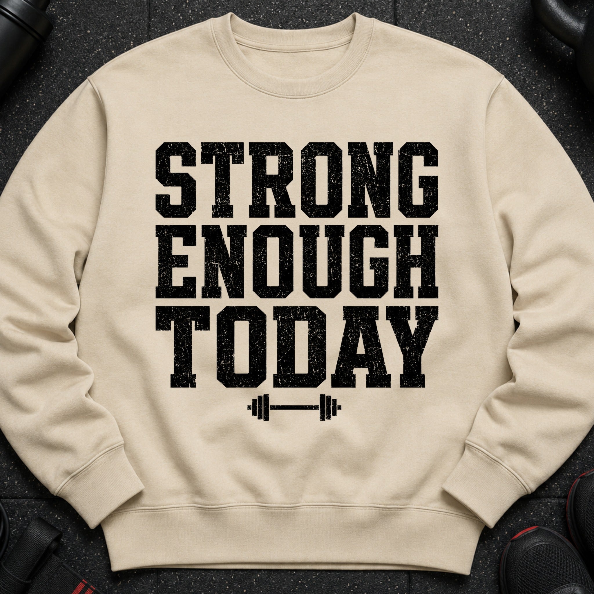 Beige sweatshirt with black distressed "STRONG ENOUGH TODAY" text and barbell graphic.