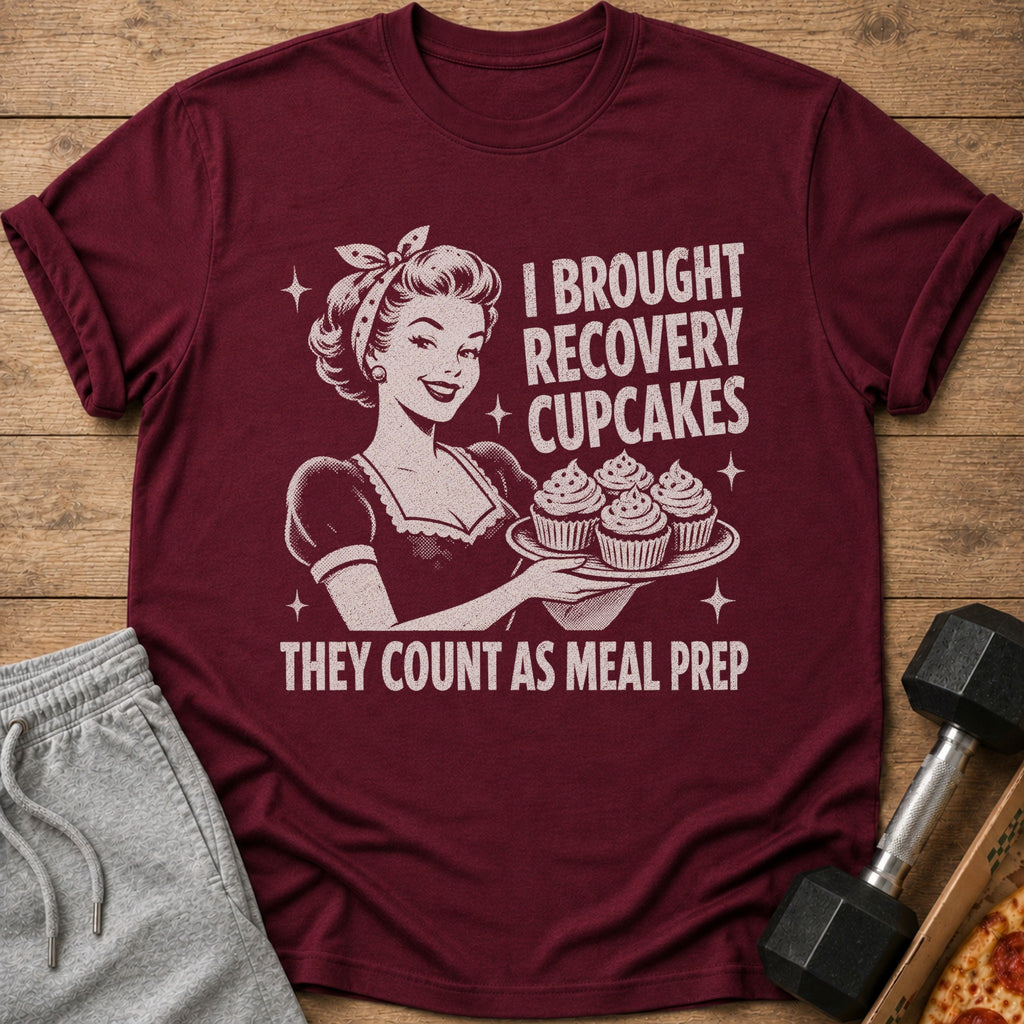 Maroon t-shirt with graphic of woman holding cupcakes and text "I BROUGHT RECOVERY CUPCAKES THEY COUNT AS MEAL PREP".