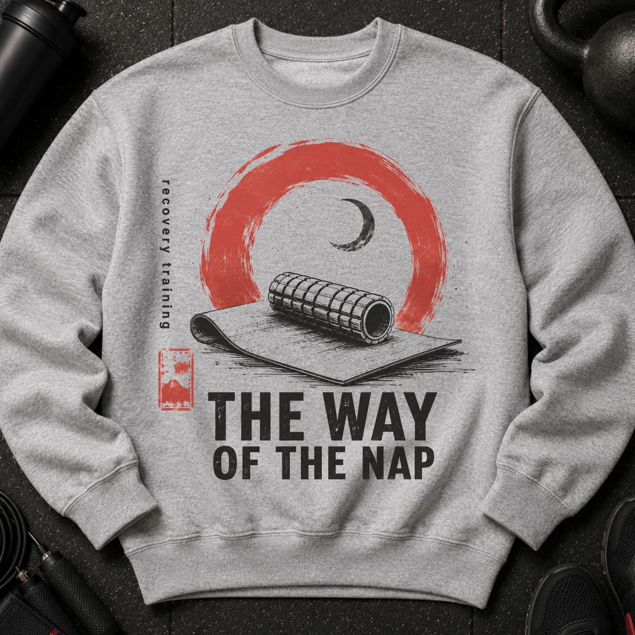 Gray sweatshirt with a design featuring a foam roller, text "THE WAY OF THE NAP," and "recovery training."