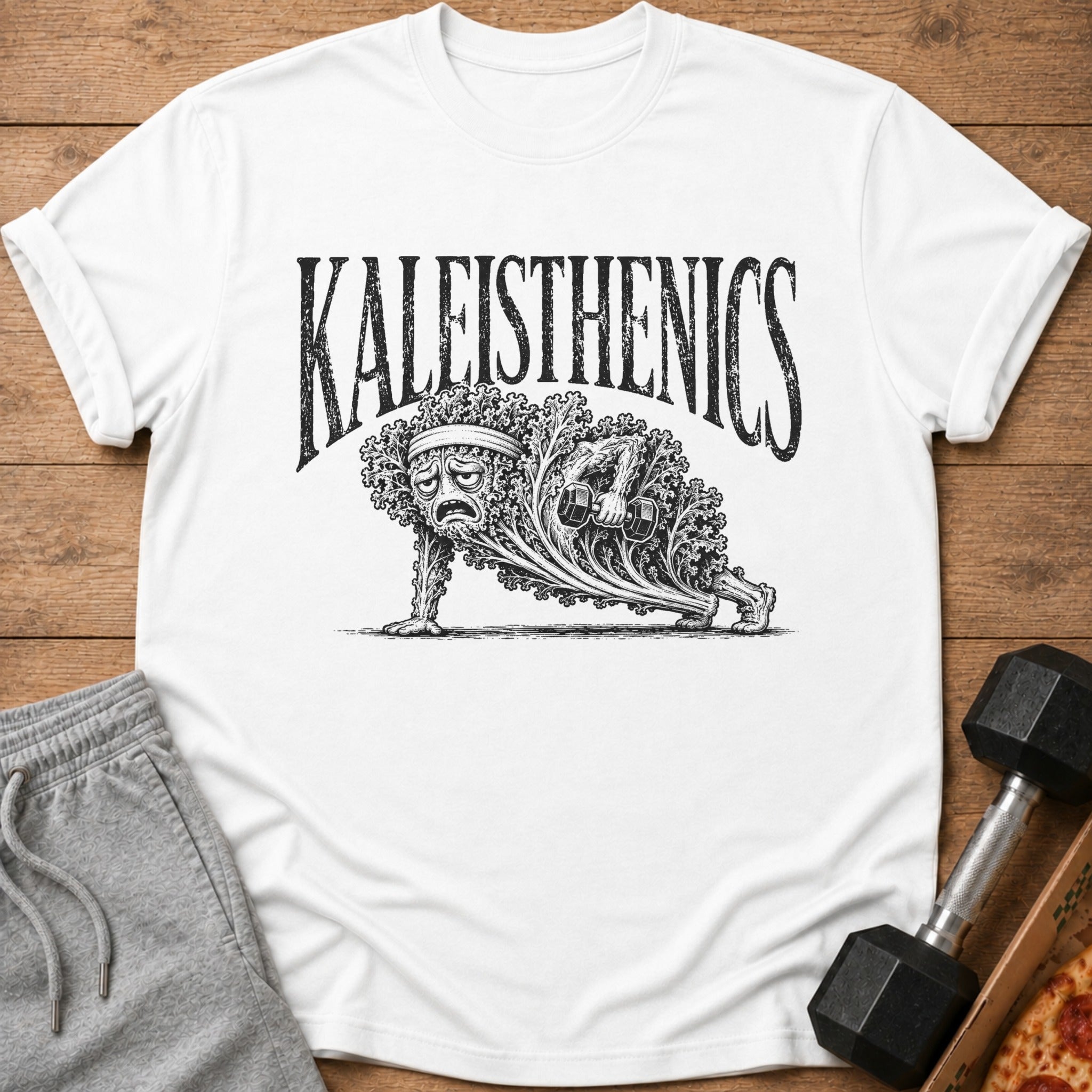 Kaleisthenics text above a sad kale plant doing a plank with a dumbbell.