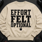 Tan sweatshirt with black distressed text "EFFORT FELT OPTIONAL" and a kettlebell graphic.