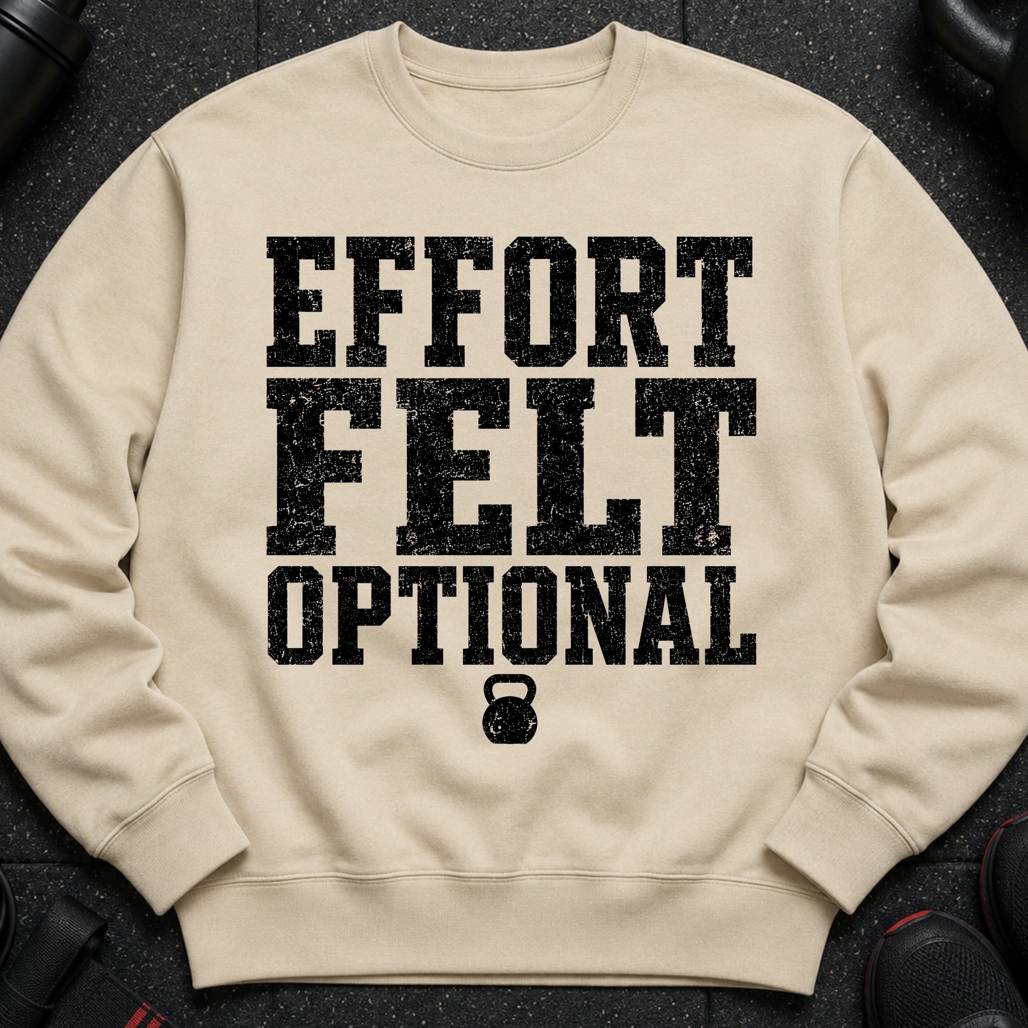 Tan sweatshirt with black distressed text "EFFORT FELT OPTIONAL" and a kettlebell graphic.