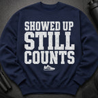Navy sweatshirt with white distressed text "SHOWED UP STILL COUNTS" and a sneaker.