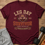 Maroon t-shirt with "LEG DAY SURVIVOR" text, a pug, and dumbbells.