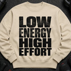 Beige sweatshirt with black distressed text "LOW ENERGY HIGH EFFORT".