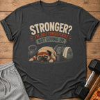 Dark t-shirt with pug and gym equipment, reads "Stronger? I'm just consistently not giving up."