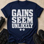 Navy t-shirt with white distressed text saying GAINS SEEM UNLIKELY and a dumbbell graphic.